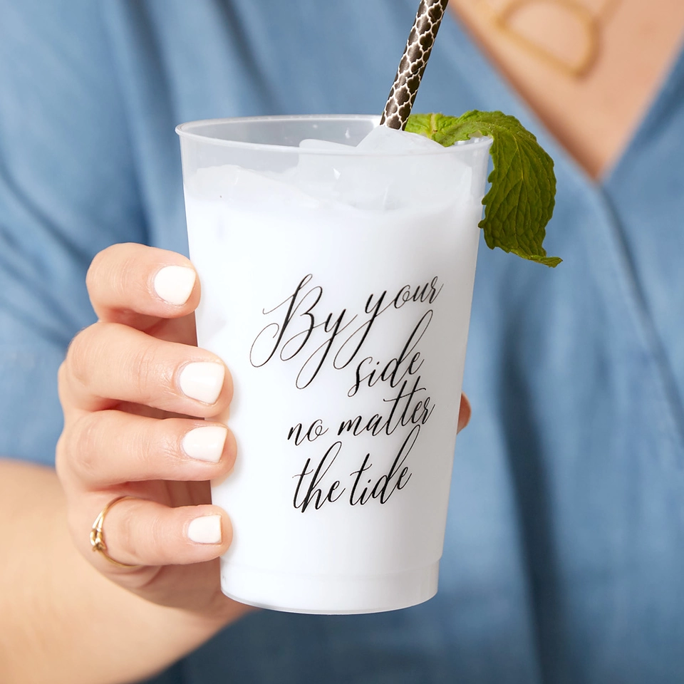 Close-up of cup that says “By your side no matter the tide”