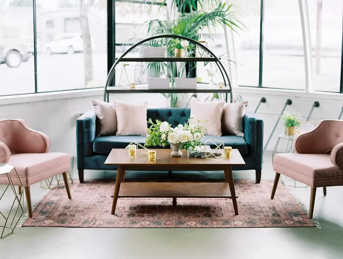 chic mingling corner with navy and blush seating and gold accents