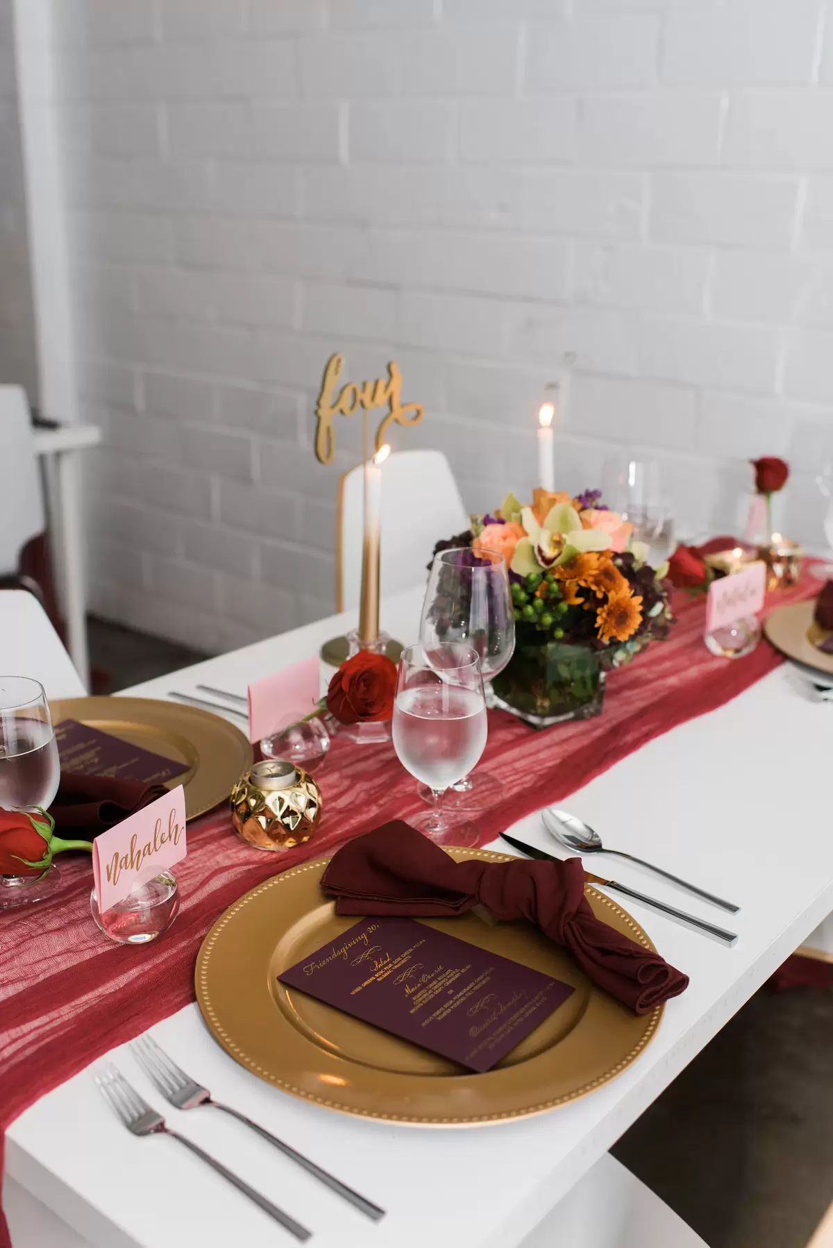red and maroon table decorations with gold charger