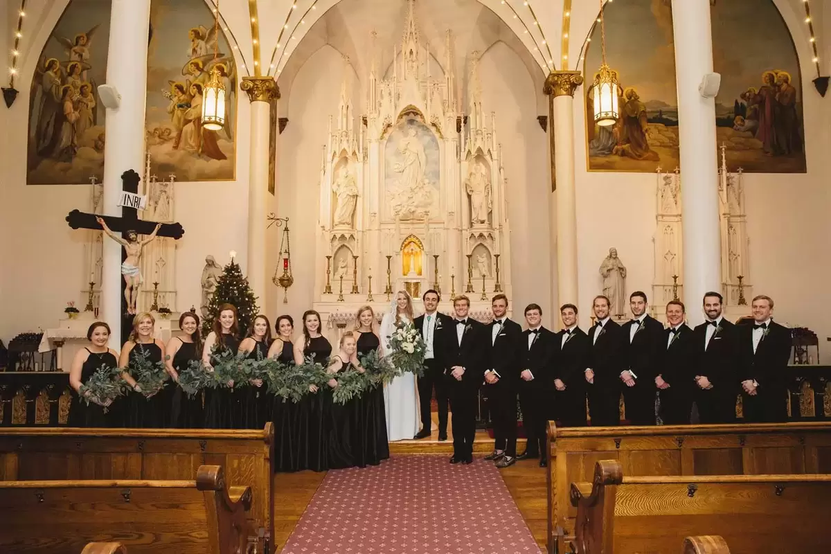 winter bridal party with black and greenery