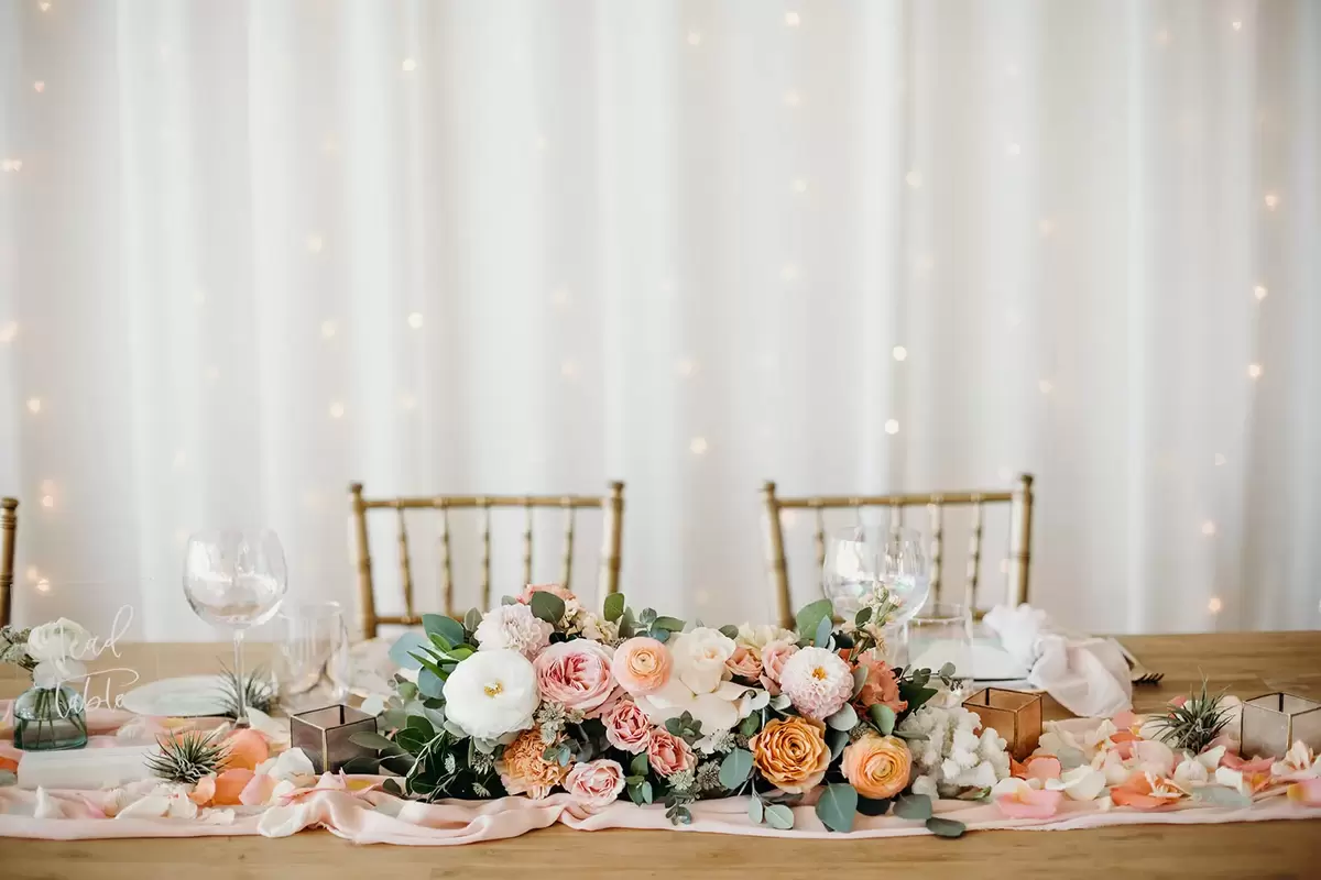 sweetheart table with twinkle lights and tulle