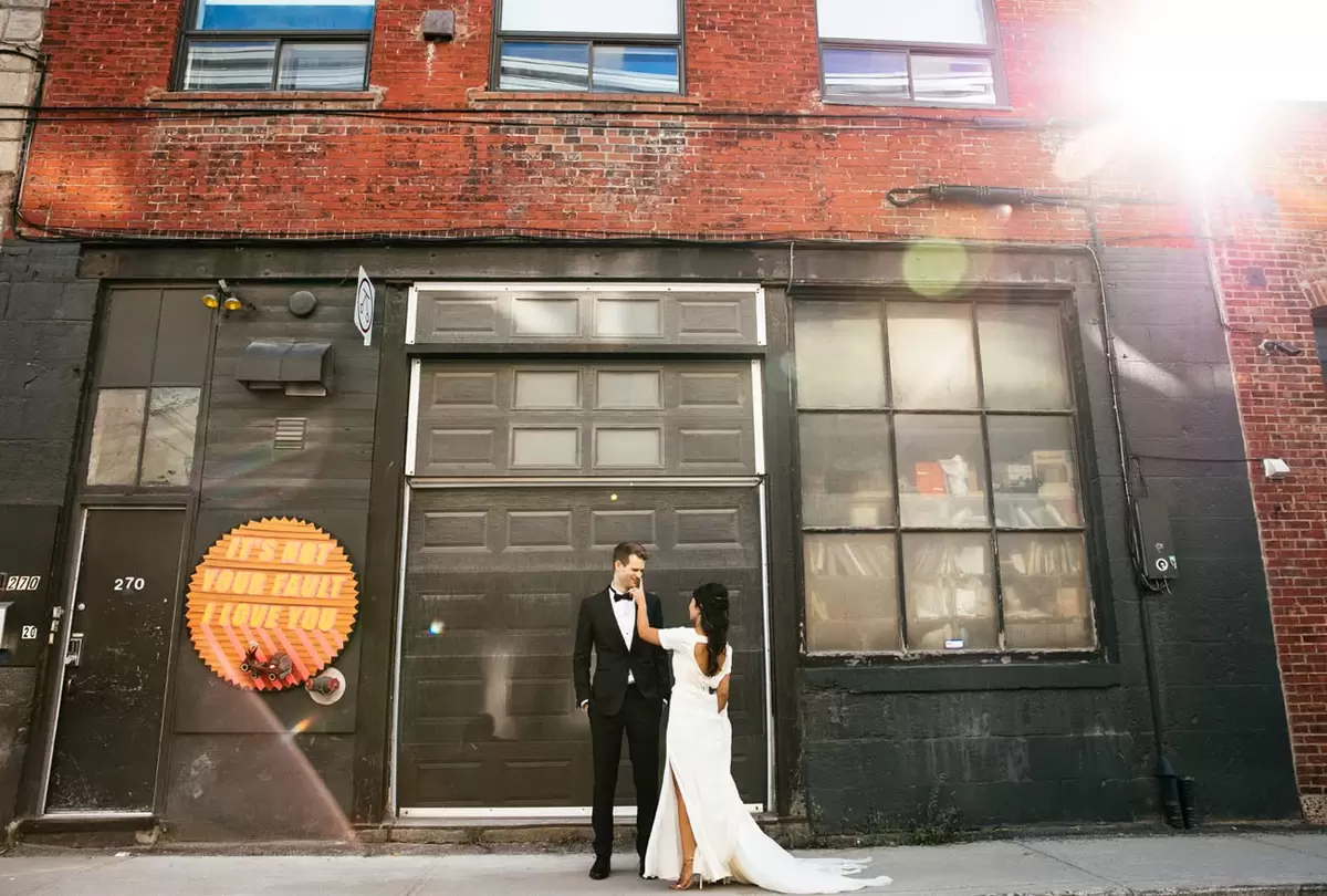 gorgeous wedding couple posed in urban setting