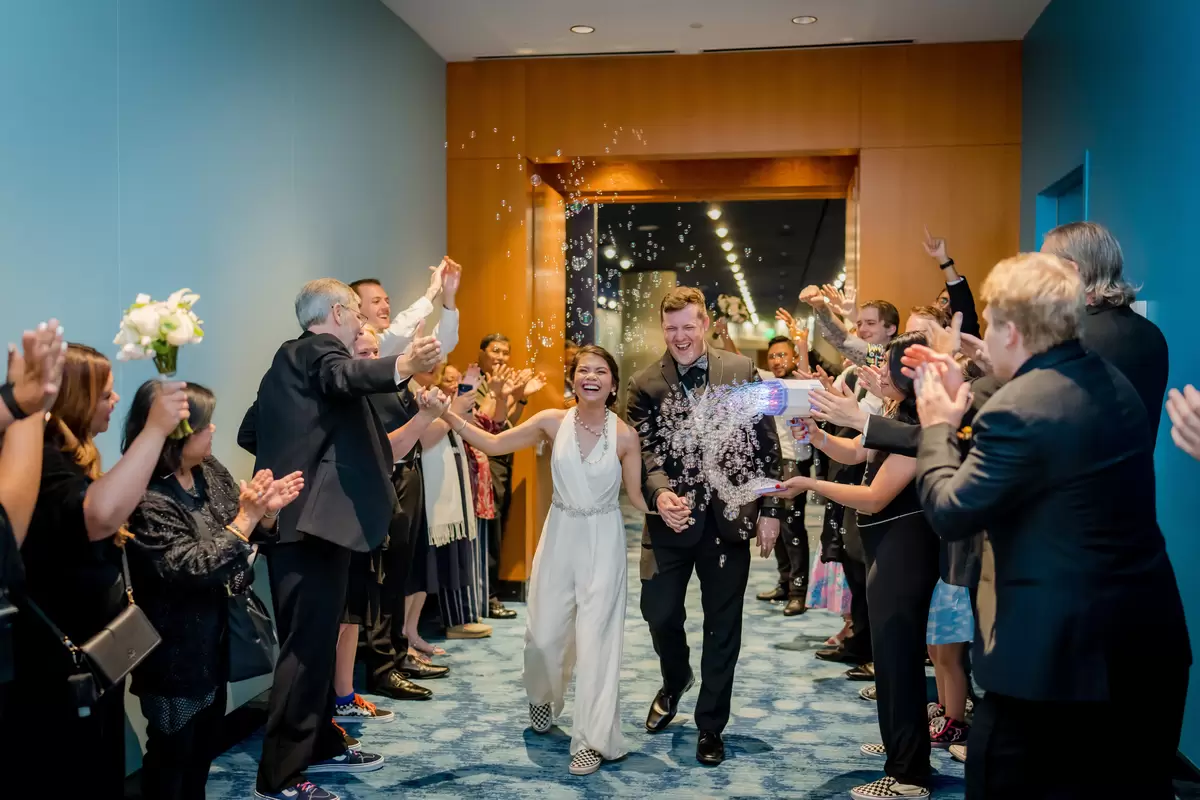 people cheering newlyweds at a semi formal wedding